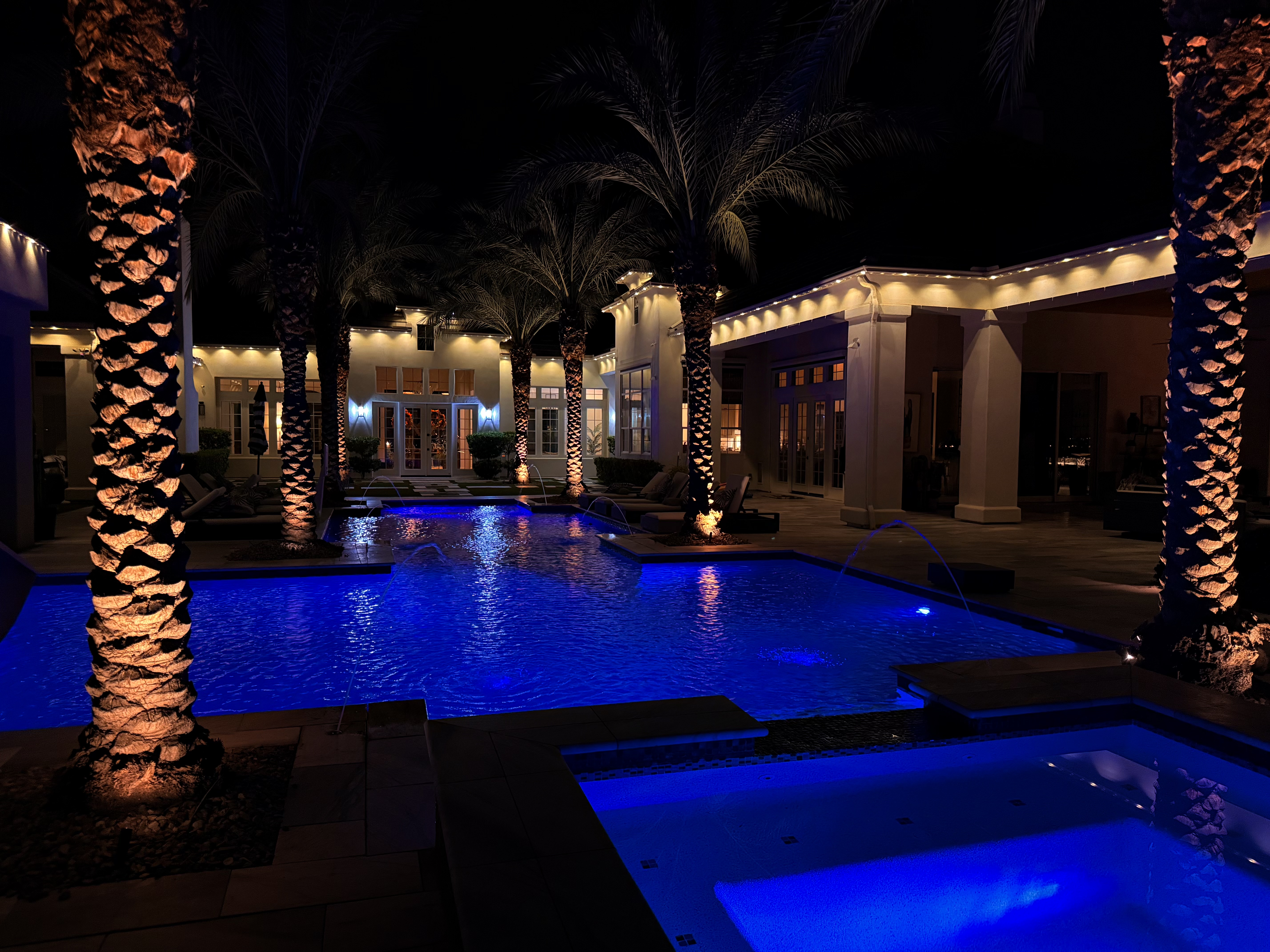 Evening home featuring custom LED eave lighting